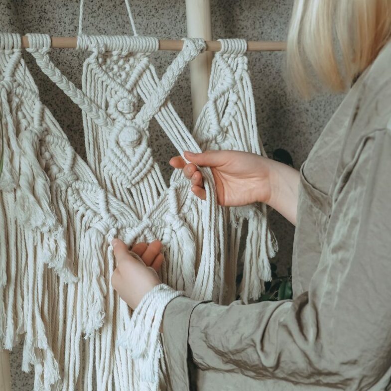 Macrame.Woman weaves home decor from cotton thread macrame pattern.Handmade in macrame technique